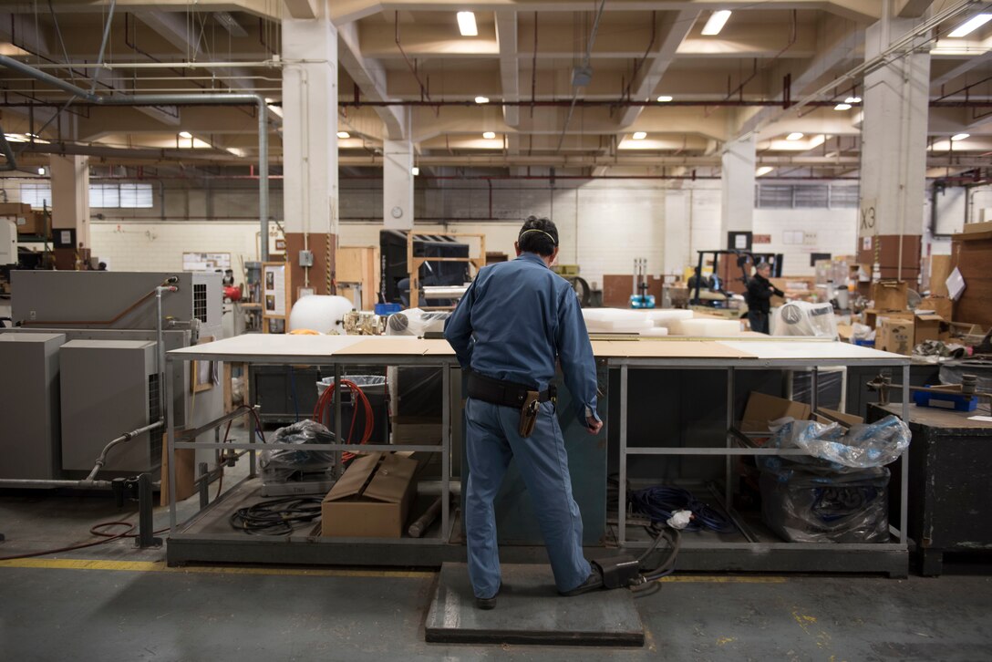 Mura Tada, 18th Logistics Readiness Squadron Traffic Management Office outbound specialist, constructs custom sized shipping boxes Feb. 14, 2018, at Kadena Air Base, Japan. TMO is capable of constructing custom sized packaging for small objects like screws or for larger items such as aircraft propellers. (U.S. Air Force photo by Senior Airman Omari Bernard)