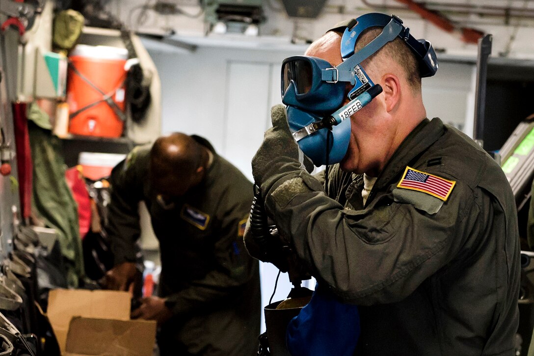 Air Force Capt. Coby Boyd tests medical equipment before conducting an in-flight aeromedical evacuation training exercise.