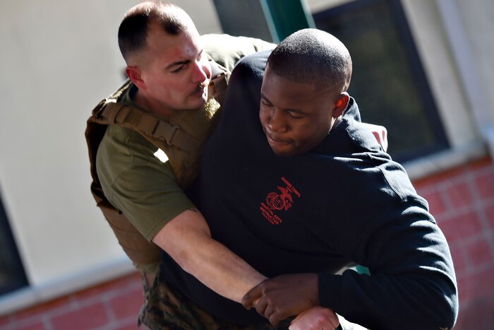 Two men practice martial arts moves.