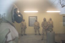Marines from various Fleet Anti-terrorism Security Teams wait for instructions inside a CS gas chamber during a protective mask verification exercise aboard Naval Weapons Station Yorktown, Va., Feb. 14. The exercise is designed to ensure their equipment is in full-working order so they are confident should they need it in a real-life situation. (Official U.S. Marine Corps photo by Chris Jones/Released)