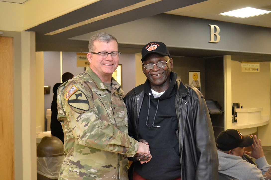 Army Brig. Gen. Mark Simerly, DLA Troop Support commander, shakes hands with a patient at the Corporal Michael J. Crescenz Veterans Affairs Medical Center Feb. 12, 2018 in Philadelphia.