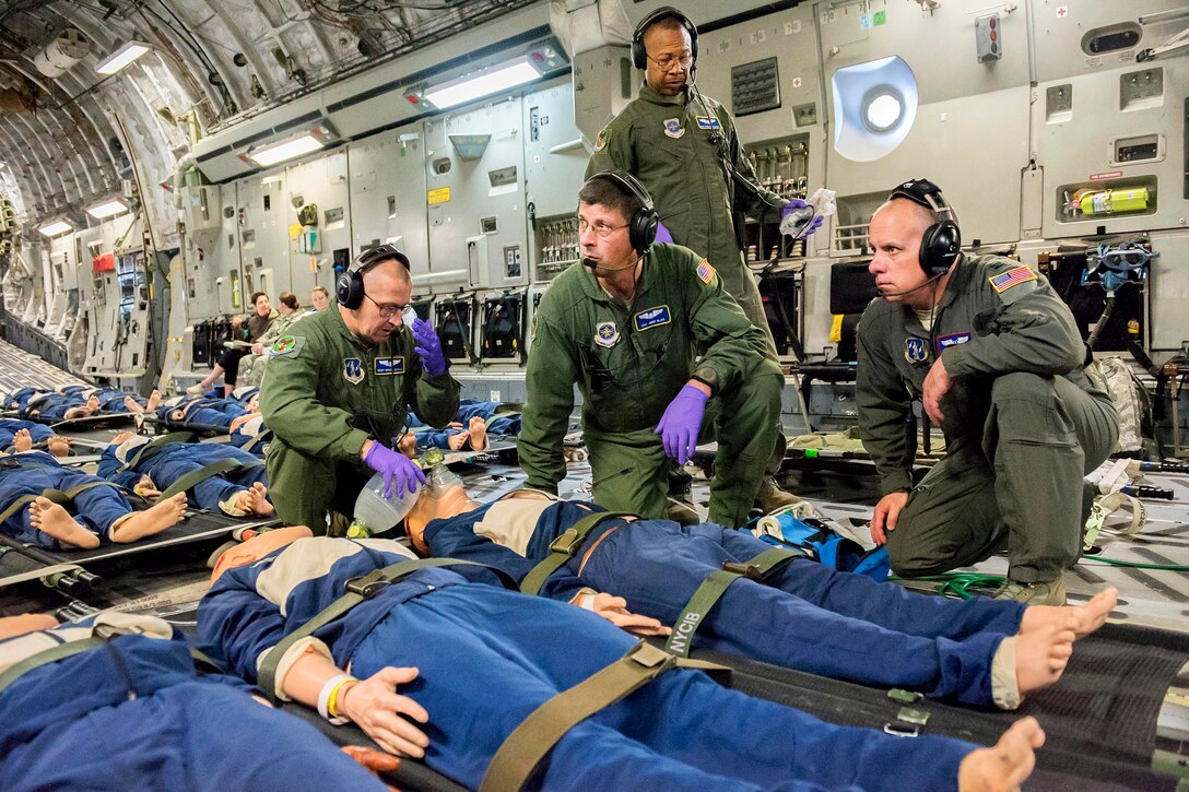 Airmen conduct emergency cardiopulmonary resuscitation during an in-flight aeromedical evacuation training exercise.