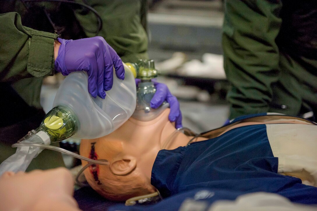 An airman performs emergency cardiopulmonary resuscitation during an in-flight aeromedical evacuation training exercise.