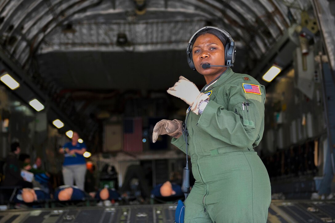 Air Force Maj. Patricia Yates coordinates patient off-loading during an in-flight aeromedical evacuation training exercise.