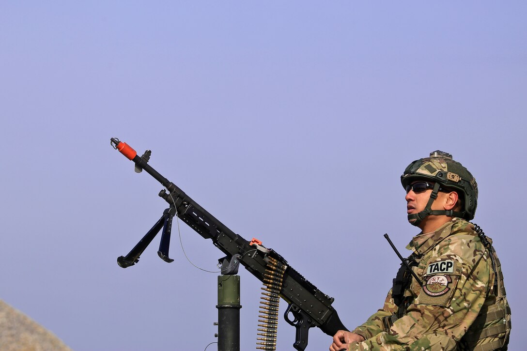 Air Force Senior Airman Victor Dulay provides security in the gunners' turret with an M240B machine gun.
