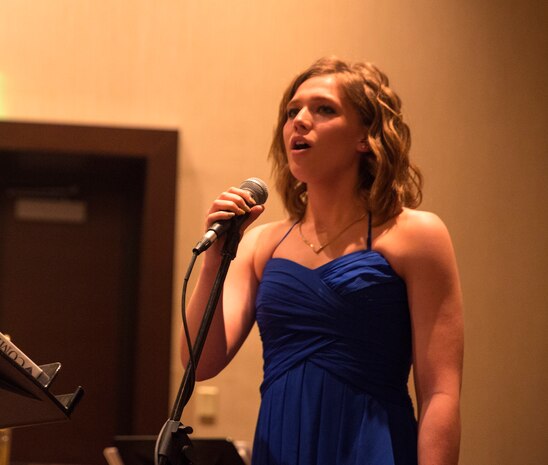 Katelyn Shaver sings for the attendees of the West Coast Senior Enlisted Professional Dinner at Valley Center, Calif., Feb. 8, 2018.