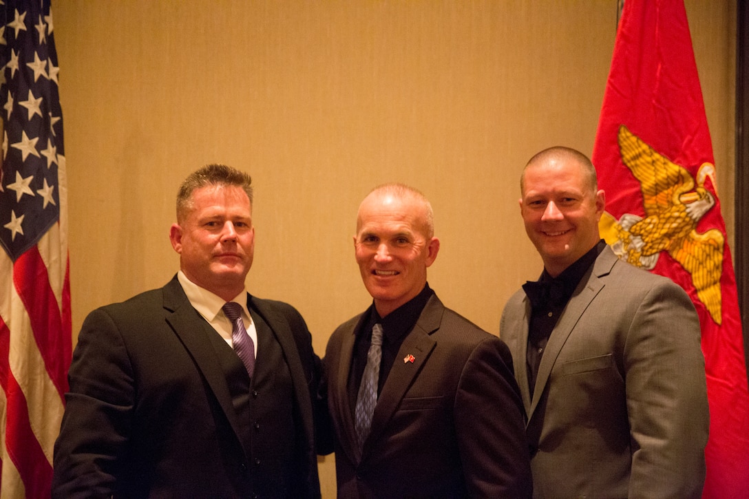 Master Gunnery Sgt. Douglas Fraser, G-3 operations chief, I Marine Expeditionary Force, Sgt. Maj. Bradley Kasal, Sergeant Major, I MEF, and 1st Sgt. John Miller, first sergeant, Headquarters Company, I MEF Information Group, pose for a photo during the West Coast Senior Enlisted Professional Dinner at Valley Center, Calif., Feb. 8, 2018.