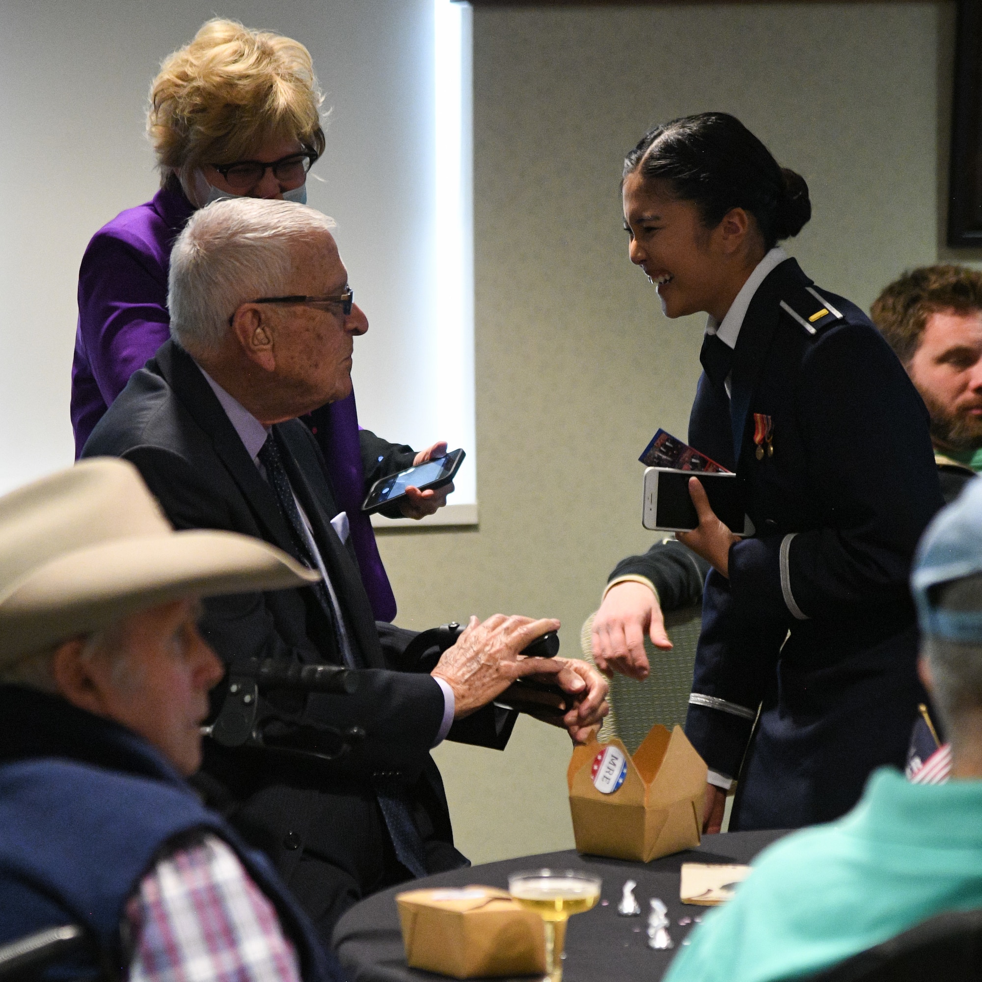 2nd Lt. Khaimook Grosshuesch speaks with three-war veteran Bob Ramos during a Valentine's Day dance held at the George E. Wahlen Veterans Home in Ogden, Utah, Feb. 14, 2018. (U.S. Air Force photo by R. Nial Bradshaw)