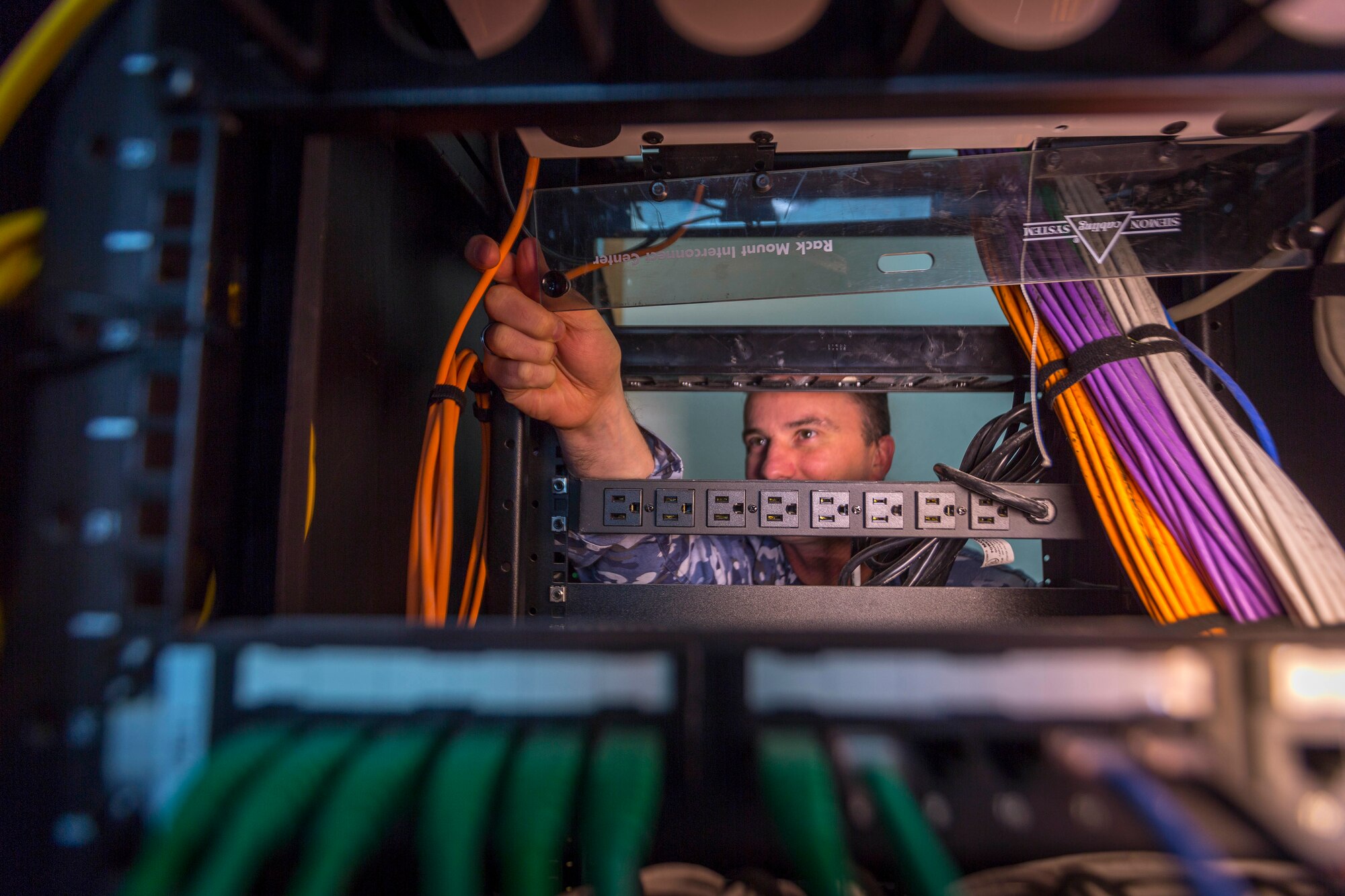 Sergeant Liam Stewart from Number 1 Combat Communications Squadron maintains the server rack at Nellis Air Force Base, Nevada, during Exercise Red Flag 18-1. (Courtesy Photo)