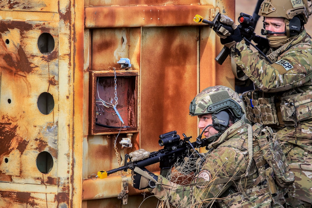 Airmen move tactically to a target building during training.