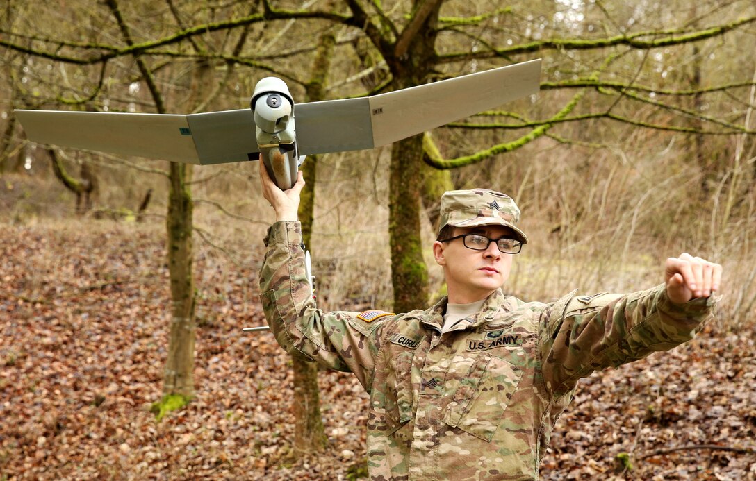 Soldier prepares to launch small drone.
