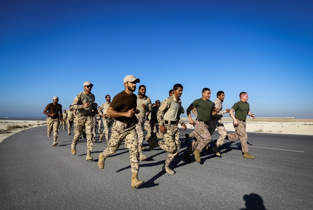 BAHRAIN (Jan. 14, 2018)  Fleet Anti-terrorism Security Team, Central Command, a subordinate command of Naval Amphibious Force, Task Force 51, 5th Marine Expeditionary Brigade – TF 51/5, and Bahrain Defense Force soldiers exercise together prior to conducting close quarters battle training. TF 51/5 staff frequently participates in subject matter expert exchange opportunities with partner nations to share expertise in respective fields and build upon partner nation capabilities in order to increase regional stability and improve interoperability. (U.S. Marine Corps photo by Sgt. Wesley Timm/Released)