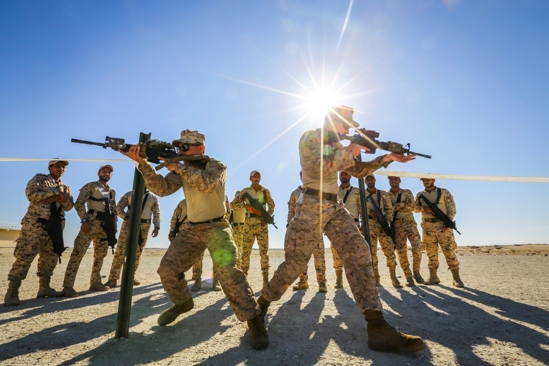 BAHRAIN (Jan. 14, 2018)  U.S. Marine Corps Cpl. Kaler Bishop (right) and Cpl. Matthew Elms (left), both riflemen attached to Fleet Anti-terrorism Security Team, Central Command, a subordinate command of Naval Amphibious Force, Task Force 51, 5th Marine Expeditionary Brigade – TF 51/5, demonstrate close quarters battle training to Bahrain Defense Force soldiers. TF 51/5 staff frequently participates in subject matter expert exchange opportunities with partner nations to share expertise in respective fields and build upon partner nation capabilities in order to increase regional stability and improve interoperability. (U.S. Marine Corps photo by Sgt. Wesley Timm/Released)