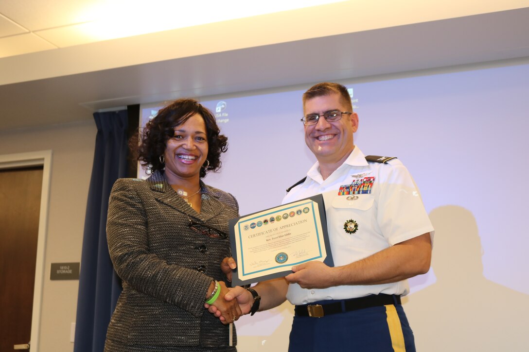 Rev. Terri Silas Eddie, social justice minister for the African Methodist Episcopalian Church for the Phoenix/San Diego District, receives a certificate from Army Col. Robert Miceli, Defense Contract Management Agency Phoenix commander. Eddie was the keynote speaker during the office’s Feb. 7 National African American History Month presentation. (DCMA photo by Marissa Krings)