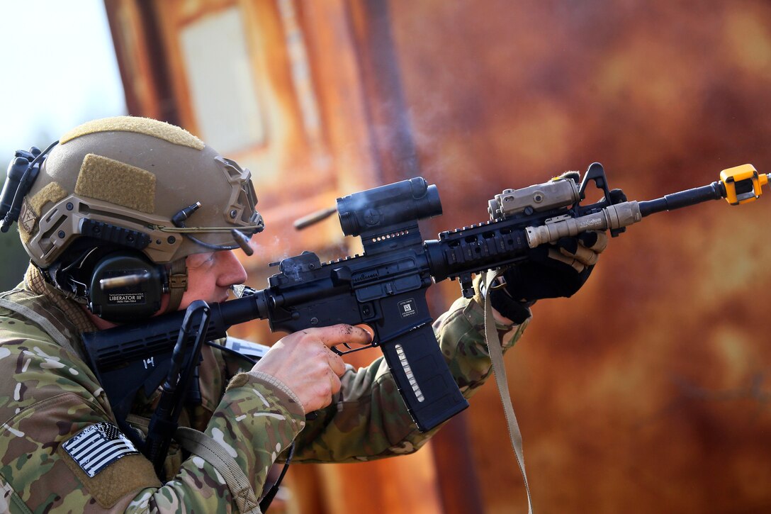 Air Force Staff Sgt. Joshua Becktell fires blank rounds at targets.