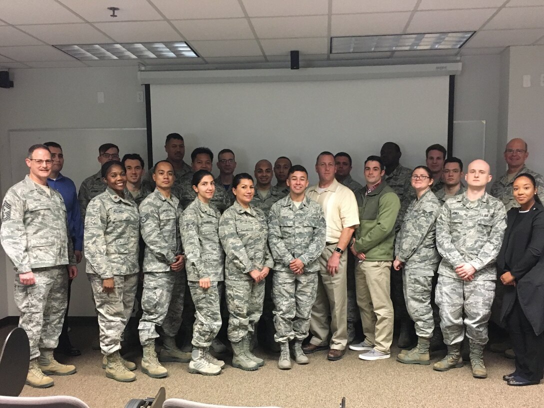 Col. Raymond Kozak (rear, far right), the 349th Air Mobility Wing commander, and Chief Master Sgt. Bryan Payne (far left), the 349th AMW command chief, welcome the newest Citizen Airmen to the Golden Gate Wing, Feb. 10, 2018.