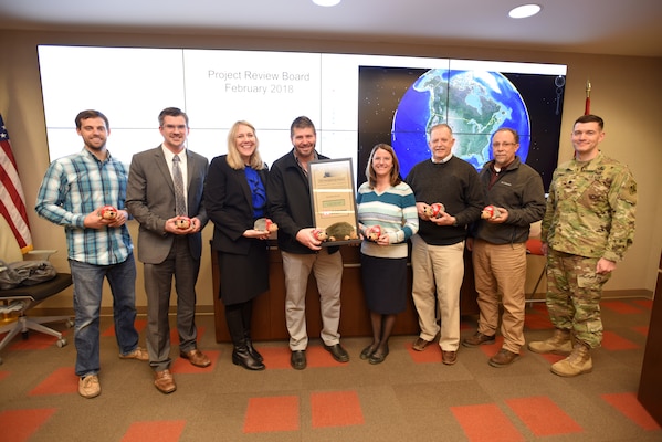 Lt. Col. Cullen Jones (Right), U.S. Army Corps of Engineers Nashville District commander, presents the Hedgehog Award to a team credited with ensuring a construction project for the U.S. Department of Energy at Oak Ridge, Tenn., finished on time and $5 million under budget. The award is given quarterly by the Nashville District to individuals or team of employees to recognize excellence at the district’s headquarters in Nashville, Tenn. Those present at the presentation are (Left to Right) Barry Cunningham, Isaac Taylor, Bonnie Jagoditz, Jason Phillips, Jacqueline Huff, Joe Duncan, Brian Whitus, and Jones. (USACE photo by Lee Roberts)