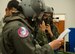 Aircrew flight equipment technicians help Airman 1st Class Steven Slover, 535th Airlift Squadron loadmaster, and Capt. Justin Stanley, 535 AS C-17 Globemaster III pilot, put on their aircrew eye and respiratory protection systems at Joint Base Pearl Harbor-Hickam, Hawaii, Feb. 9, 2018. Units across the 15th Wing routinely conduct training in protective systems to keep up with currency requirements. (U.S. Air Force photo by Tech. Sgt. Heather Redman)