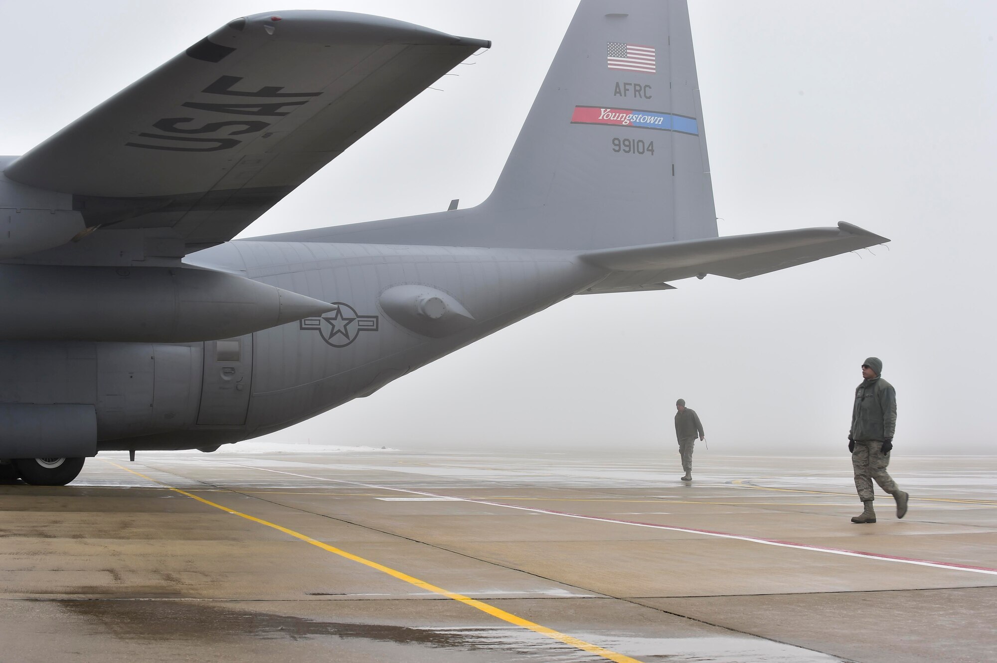 10th Aircraft Maintenance Squadron maintainers marshall a C-130H Hercules aircraft while it's being towed into a hangar here, Feb. 11, 2018.