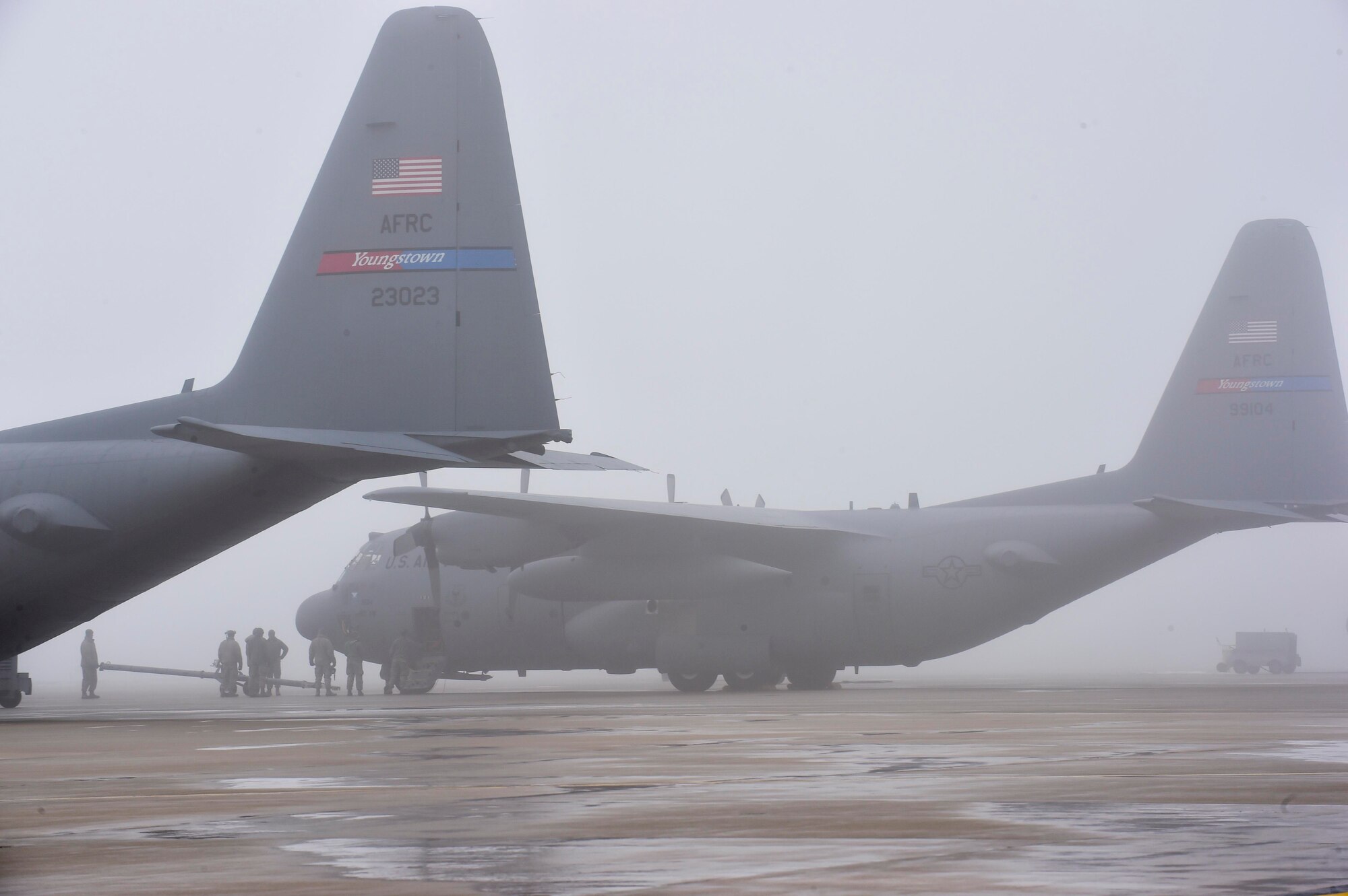 10th Aircraft Maintenance Squadron maintainers marshall a C-130H Hercules aircraft while it's being towed into a hangar here, Feb. 11, 2018.