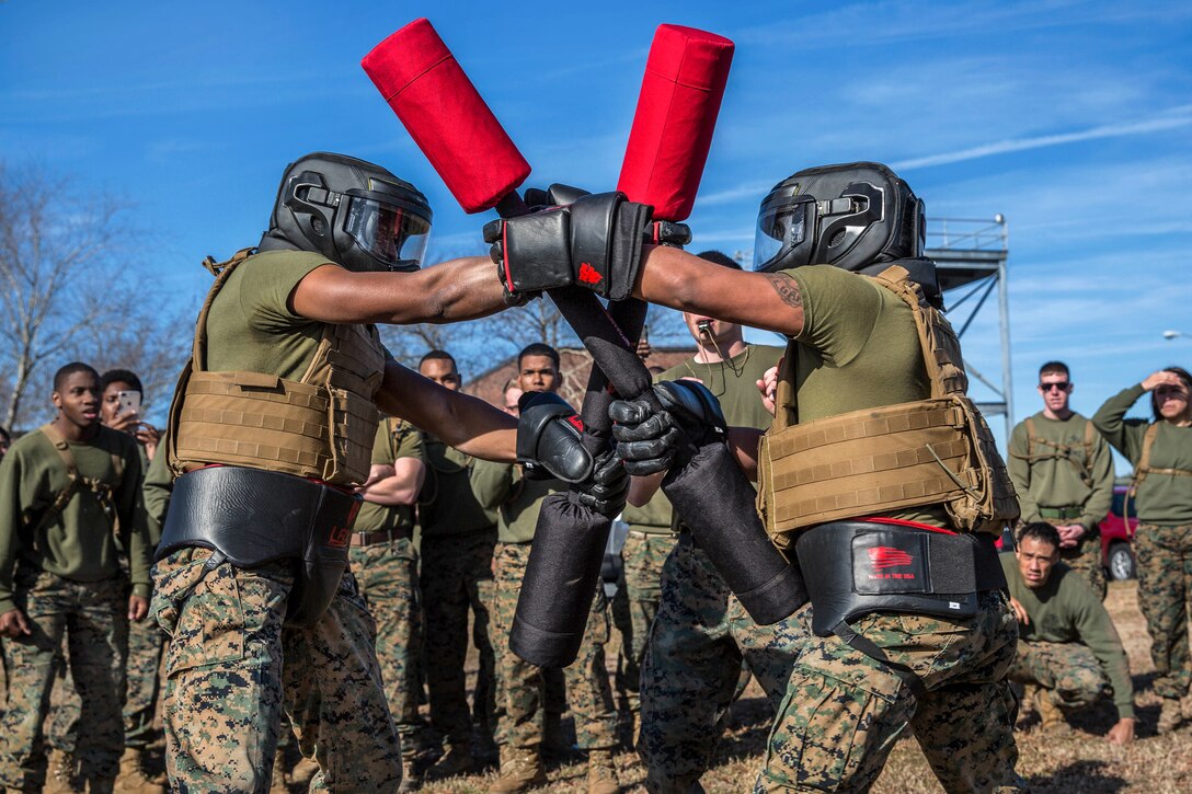 Two Marines compete against each other in a pugil stick match.