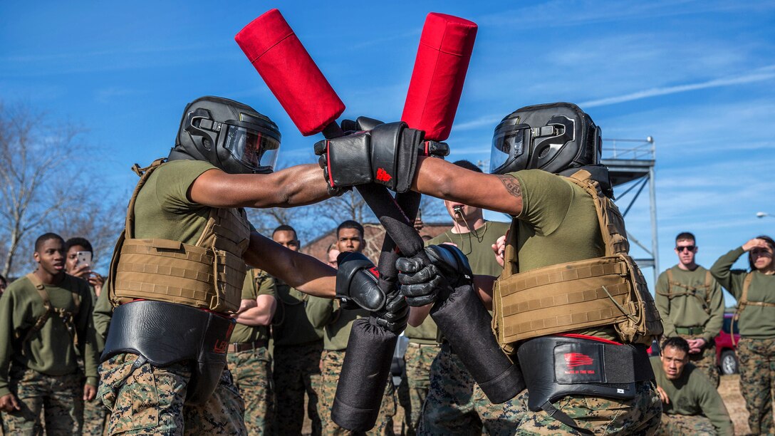 Two Marines compete against each other in a pugil stick match.
