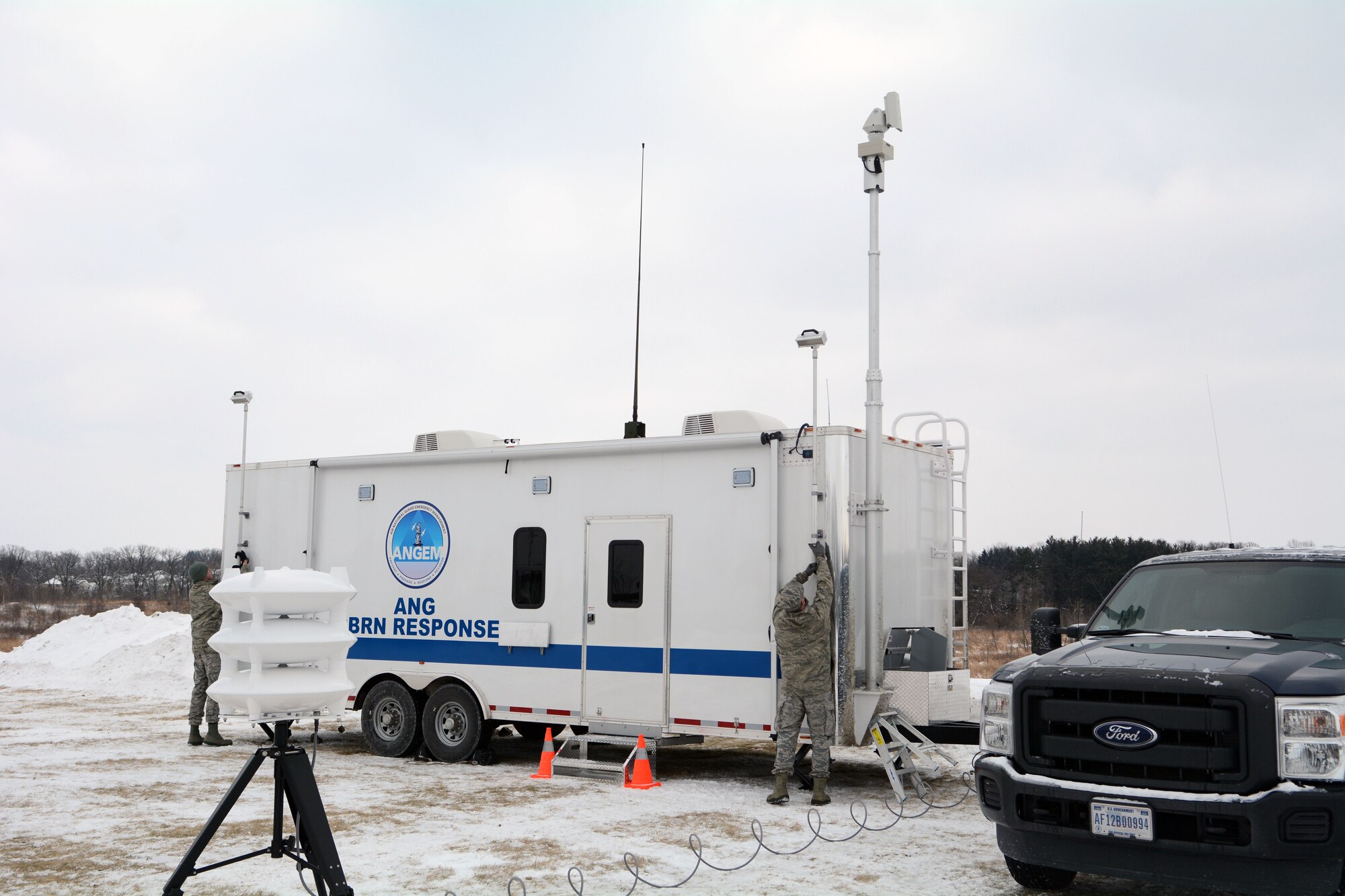 Senior Airman Cory Corson, left, and Staff Sgt. Shane Goss, Emergency Management Specialists with the 115th Fighter Wing, set up the Wisconsin Air National Guard All Hazards Emergency Response Trailer for the State Interoperable Mobile Communications Exercise (SIMCOM), in Fitchburg, Wis., Feb 7, 2018. The annual SIMCOM exercise tests the interoperability of federal, state and local emergency communications agencies. (U.S. Air National Guard photo by Tech. Sgt. Mary Greenwood)