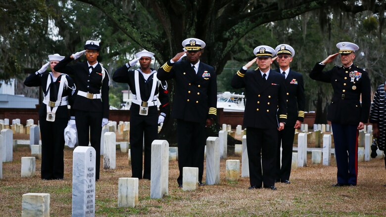 Marines and Sailors salute the headstone of Petty Officer 1st Class William Pinckney while Taps is played at the Beaufort National Cemetery, Feb. 10.