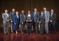 A Huntsville Center contracting officer and program manager accept a Federal Energy Management Program award at a ceremony at the National Archives in Washington D.C. Nov. 2. During the ceremony, the Federal Energy Management Program recognized a Center project expected to reduce the Defense Intelligence Agency Bethesda Maryland campus’ energy use by about 47 percent and save the agency more than $1 million annually. From left; Dr. Timothy Unruh, Department of Energy deputy assistant secretary for renewable power for the office of energy efficiency and renewable energy, Col. Jason Smallfield, Army Engineer Regiment, Barbara Osterkamp, Huntsville Center contracting officer, Lisa Harris, Huntsville Center UESC program manager, Natoya Miller, Defense Intelligence Agency, Phil Smith, Honeywell International Inc., Leslie Nicholls, Acting Director, DOE/FEMP and Ed Miller and Eric James, Washington Gas Light Co.