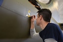 (01/25/2018) Museum restoration specialist Casey Simmons paints the letter 'S' for 'Sally' below the left waist gun position of the Boeing B-17F Memphis Belle as part of the aircraft restoration. Plans call for the aircraft to be placed on permanent public display in the WWII Gallery of the National Museum of the U.S. Air Force on May 17, 2018. (U.S. Air Force photo by Ken LaRock)