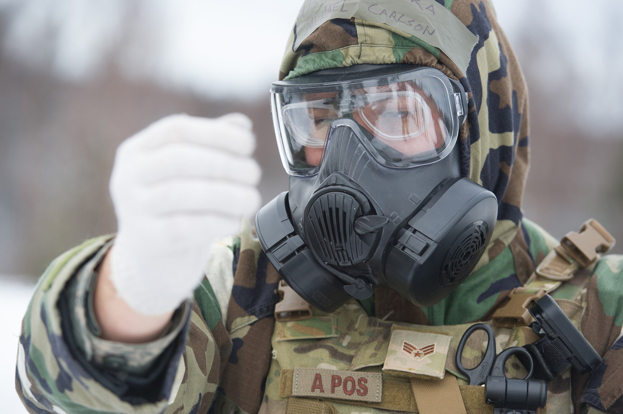 Senior Airman Michael Carlson, assigned to the 673d Civil Engineer Squadron, Explosives Ordinance Disposal Flight, quickly dons protective gear before a live-fire demolitions exercise in Mission Oriented Protective Posture 4 on Joint Base Elmendorf-Richardson, Alaska, Feb.14, 2018.  The Airmen were conducting EOD training in a simulated chemical weapons contaminated environment.