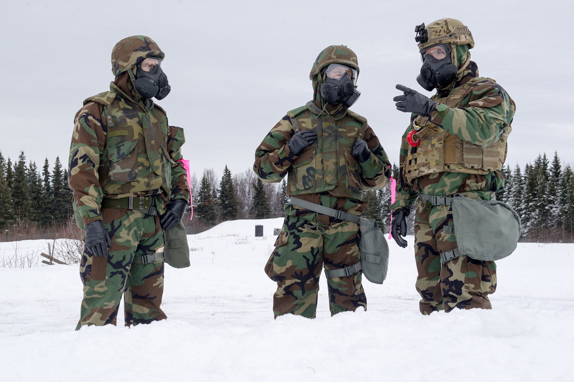 Airmen assigned to the 673d Civil Engineer Squadron, Explosives Ordinance Disposal Flight, observe preparations for a live-fire demolitions exercise in Mission Oriented Protective Posture 4 on Joint Base Elmendorf-Richardson, Alaska, Feb.14, 2018.  The Airmen were conducting EOD training in a simulated chemical weapons contaminated environment.