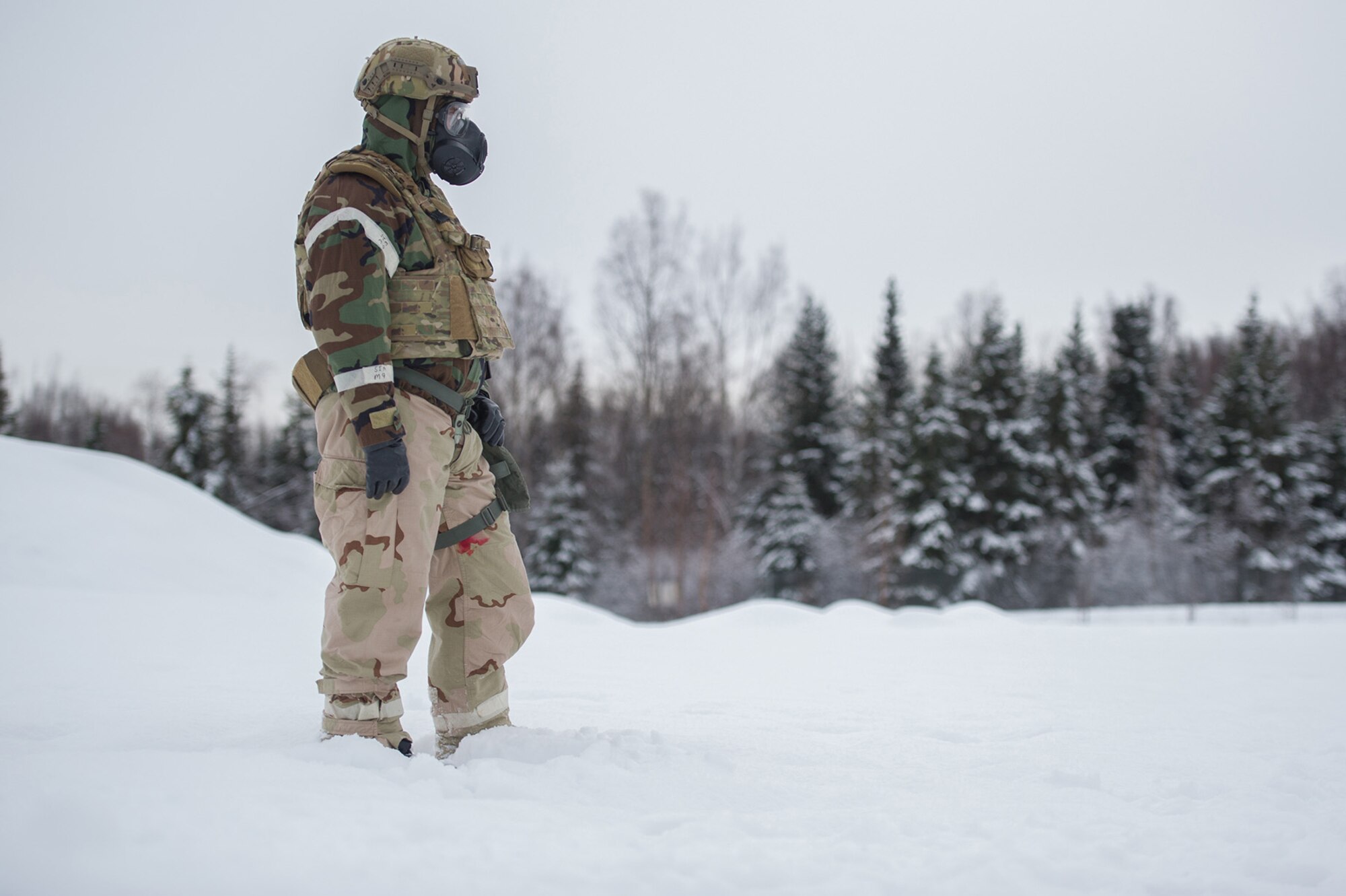 Senior Master Sgt. Ronald White observes his Airmen, assigned to the 673d Civil Engineer Squadron, Explosives Ordinance Disposal Flight, preparing for a live-fire demolitions exercise in Mission Oriented Protective Posture 4 on Joint Base Elmendorf-Richardson, Alaska, Feb.14, 2018.  The Airmen were conducting EOD training in a simulated chemical weapons contaminated environment.