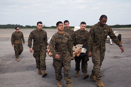 Navy, Army, and Air Force personnel perform en-route medical care training