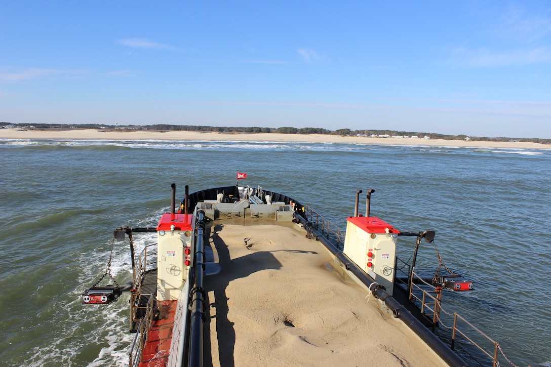 Dredge CURRITUCK prepares to empty a full load of sand offshore of Assateague Island that was just pulled from the bottom of Ocean City Inlet while conducting Assateague Bypass operations Dec. 22, 2016. Assateague Bypass operations are part of environmental restoration efforts authorized to dredge material from in and around Ocean City Inlet to be placed offshore of Assateague Island to mitigate for erosion caused by the inlet and its jetties. (U.S. Army photo by Chris Gardner)