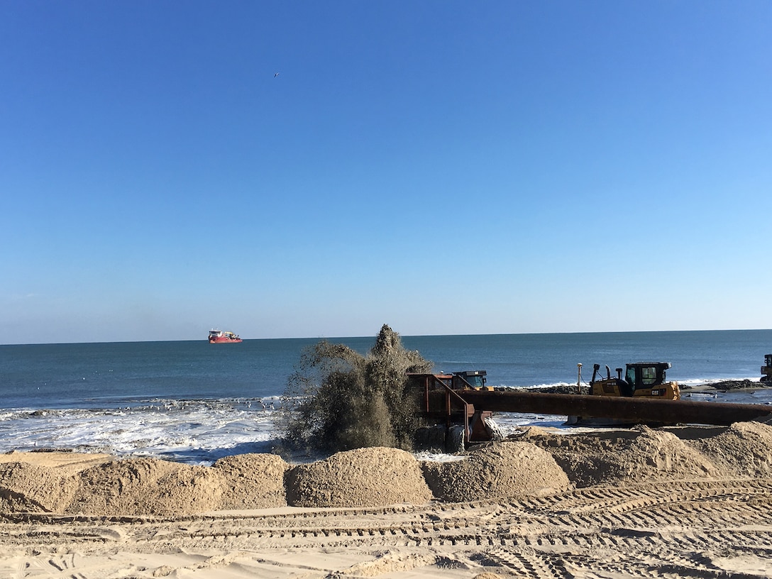 Crews carry out periodic renourishment work on the beach berm at Ocean City, Maryland Nov. 20, 2017 as part of the maintenance of the coastal storm risk management project there. The beach berm, essentially what most people think of as the beach, is engineered to reduce coastal storm risks in concert with the seawall and dune behind it. (U.S. Army photo by Chris Gardner)