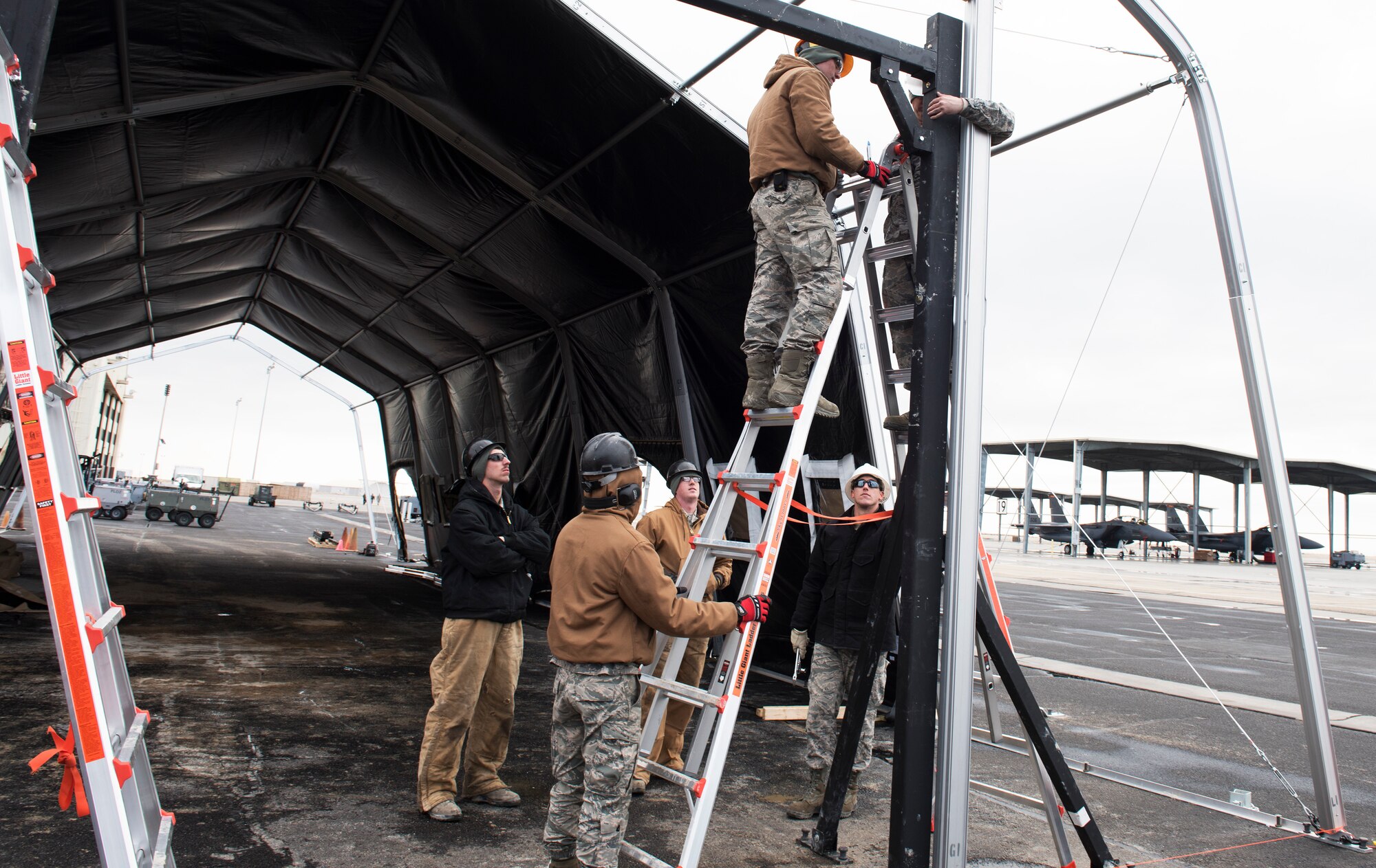 366th Civil Engineer Squadron Airmen move heavy equipment in support of erecting a temporary maintenance facility.