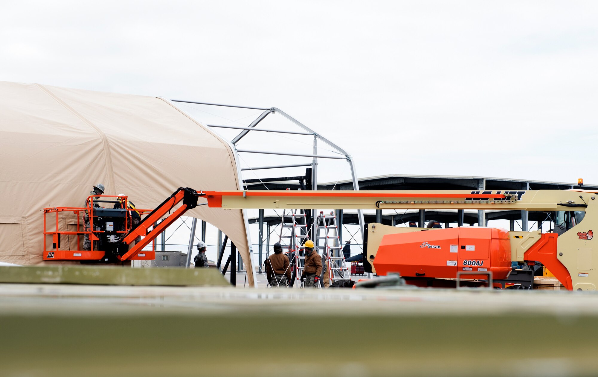 366th Civil Engineer Squadron Airmen move heavy equipment in support of erecting a temporary maintenance facility.