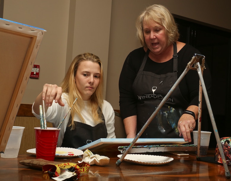 A Marine gets direction from an instructor during a Single
Marine Program sponsored “Singles Painting Party”
aboard Marine Corps Air Station Beaufort, Feb. 14. The
SMP was founded to provide opportunities and improve
the quality of life for single Marines and Sailors.