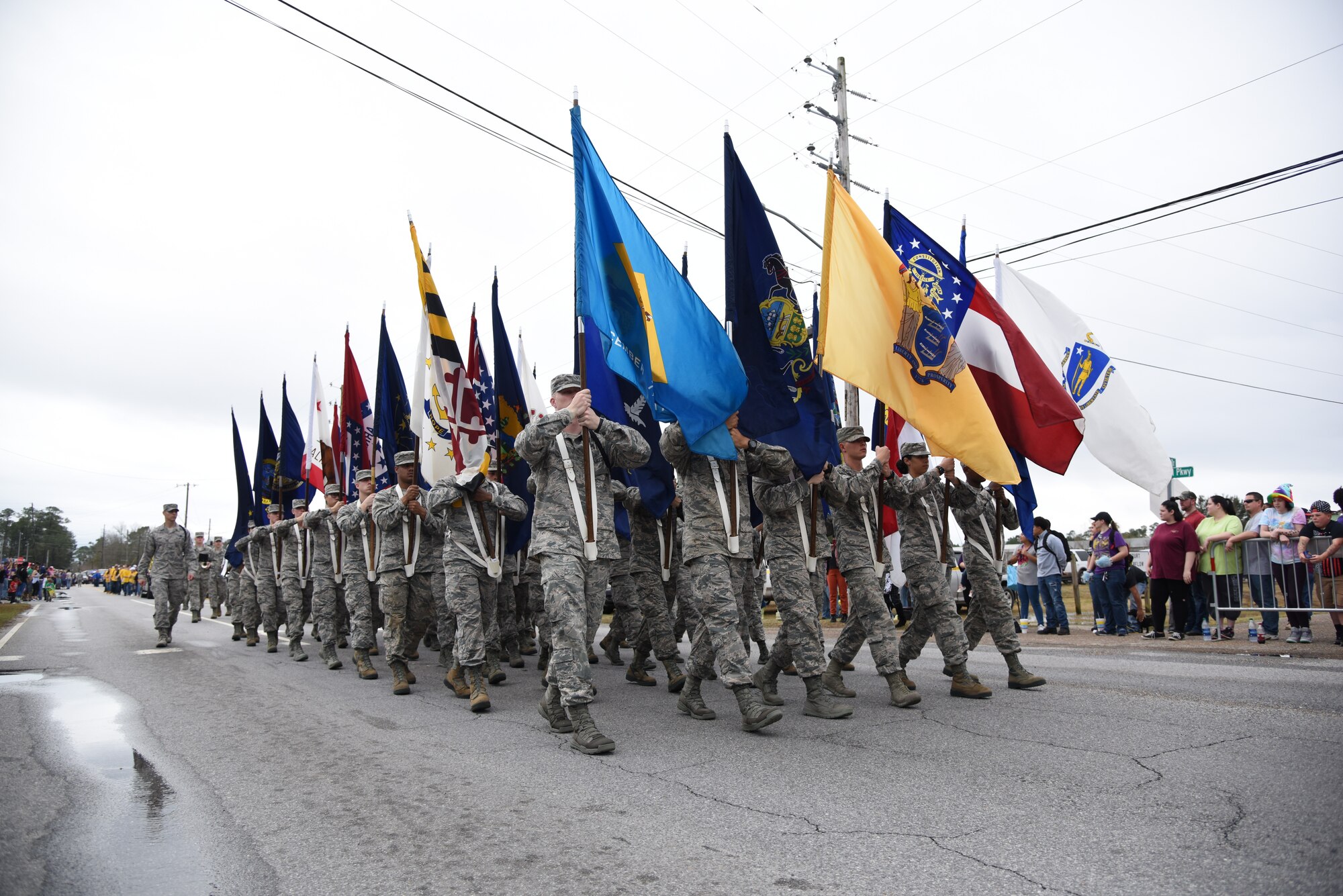 Keesler Airmen carry the 50 state flags in the North Bay Area Mardi Gras Parade Feb. 11, 2018, in D’Iberville, Mississippi. Keesler personnel participate in local parades every Mardi Gras season to show their support of the communities surrounding the installation. (U.S. Air Force photo by Kemberly Groue)