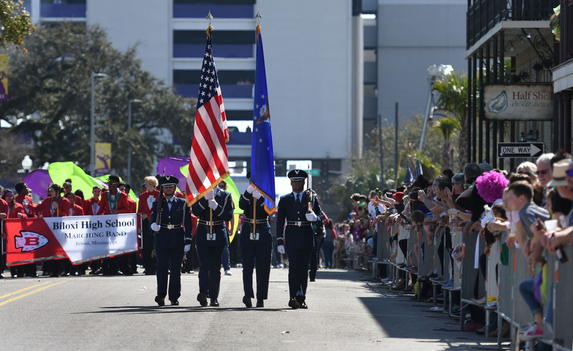 Members of the Keesler Air Force Base Honor Guard lead the Gulf Coast Carnival Association Mardi Gras parade Feb. 13, 2018, in Biloxi, Mississippi. Keesler personnel participate in local parades every Mardi Gras season to show their support of the communities surrounding the installation. (U.S. Air Force photo by Kemberly Groue)