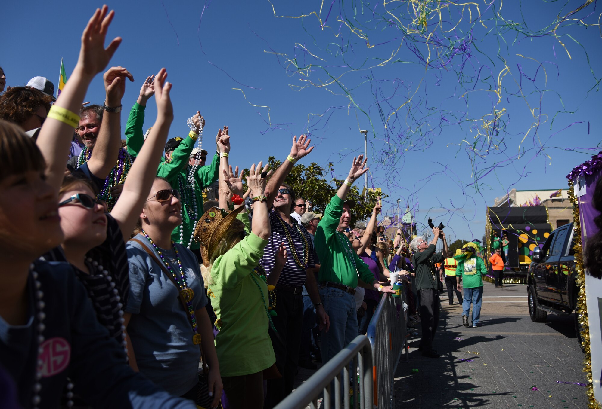 Parade attendees cheer during the Gulf Coast Carnival Association Mardi Gras parade Feb. 13, 2018, in Biloxi, Mississippi. Keesler personnel participate in local parades every Mardi Gras season to show their support of the communities surrounding the installation. (U.S. Air Force photo by Kemberly Groue)