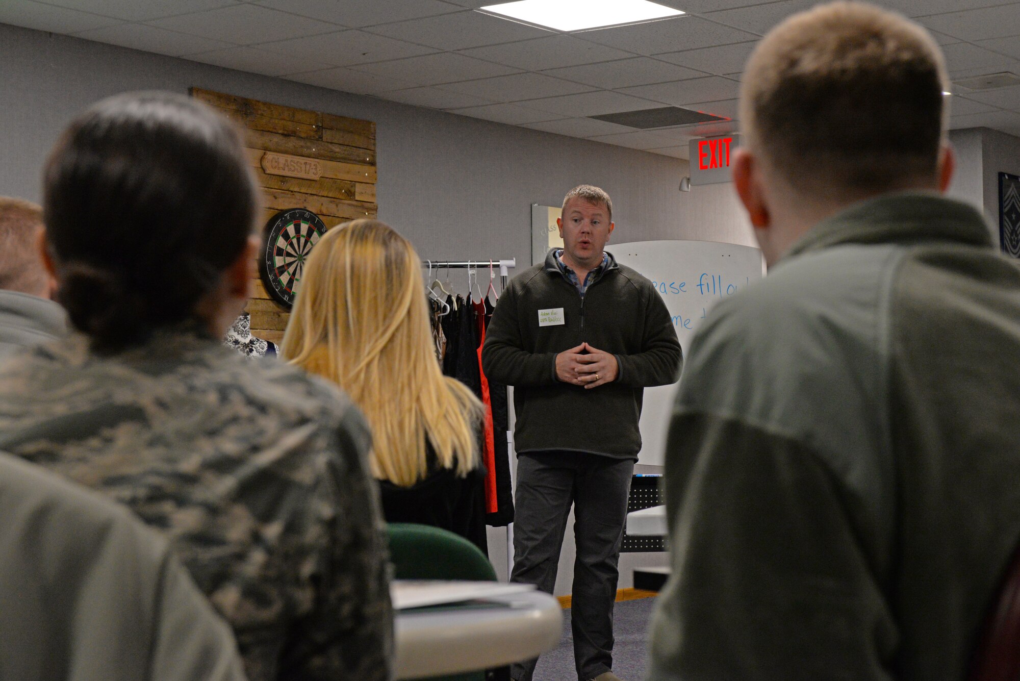 Chief Master Sgt. Adam Vizi, the 28th Bomb Wing command chief, briefs a group of Airmen and their spouses on appropriate attire during the first spouse’s orientation program in the Samuel O. Turner building at Ellsworth Air Force Base, S.D., Jan. 12, 2018. During the course, attendees learned about the appropriate attire for formal military events, the importance of creating networks and proper military etiquette. (U.S. Air Force photo by Airman 1st Class Nicolas Z. Erwin)