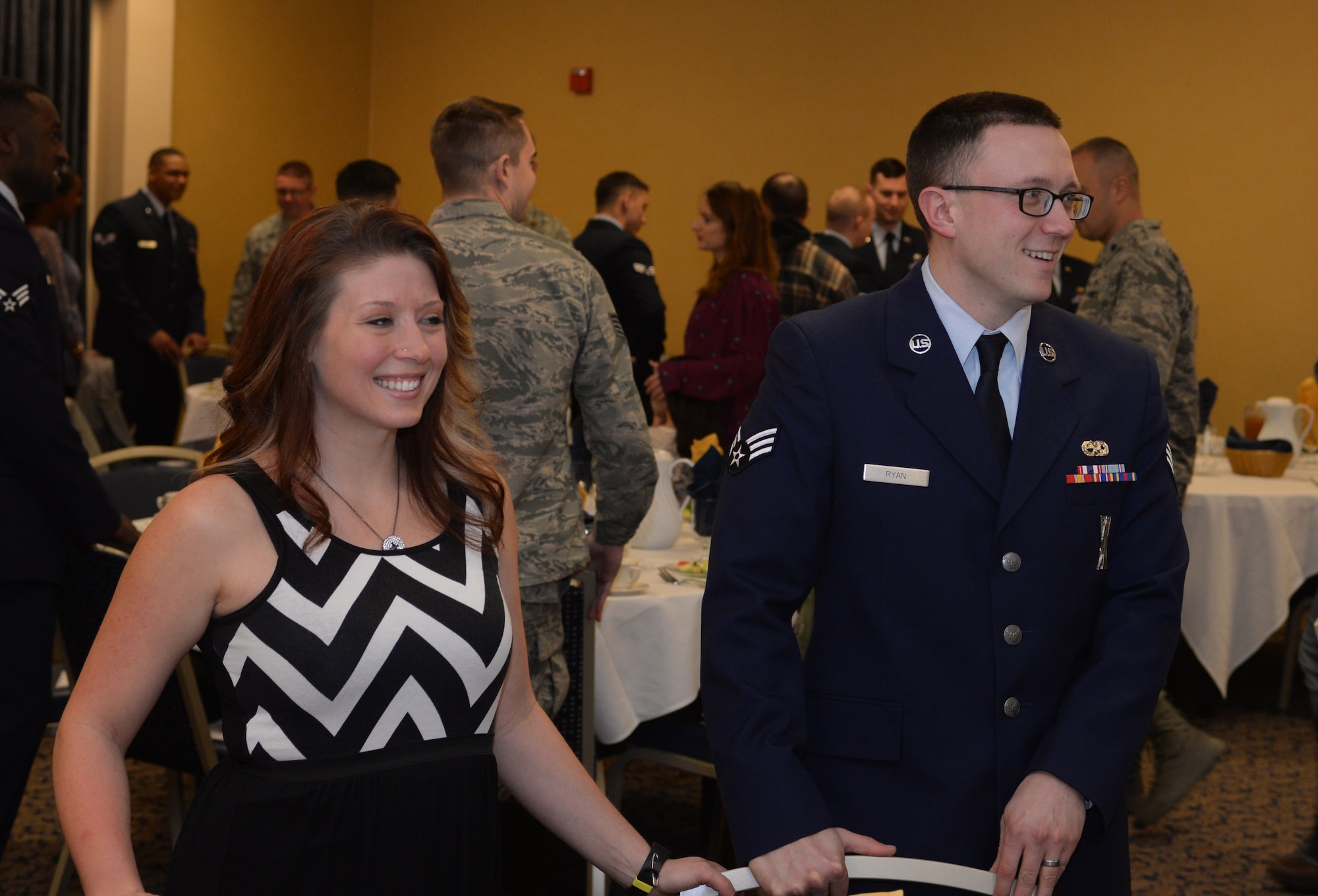 Heather Ryan, left, and her spouse Senior Airman Michael Ryan, a 28th Munitions Squadron armament systems crew member, mingle with other attendees during an Airman Leadership School graduation in the Dakota’s Club at Ellsworth Air Force Base, S.D., Feb. 2, 2018. Prior to the graduation, spouses and their Airmen had the opportunity to attend the first spouse’s orientation program, which provided attendees the chance to ask questions and receive clarification on issues such as appropriate attire and etiquette. (U.S. Air Force photo by Airman 1st Class Thomas I. Karol)