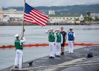 USS Texas (SSN 775) render honors to the national ensign following the completion of a Western Pacific deployment in support of national security, Feb. 14.
