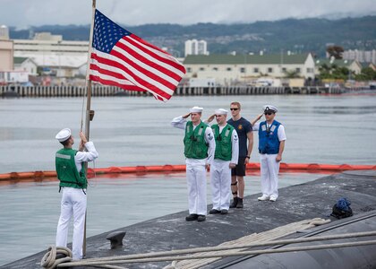 USS Texas (SSN 775) render honors to the national ensign following the completion of a Western Pacific deployment in support of national security, Feb. 14.