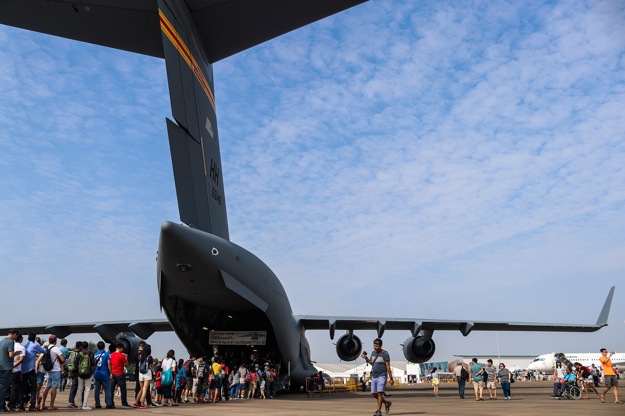 People wait in line to view the inside of a C-17 Globemaster III, during the Singapore International Airshow at Changi Exhibition Centre, Singapore, Feb. 10, 2018.