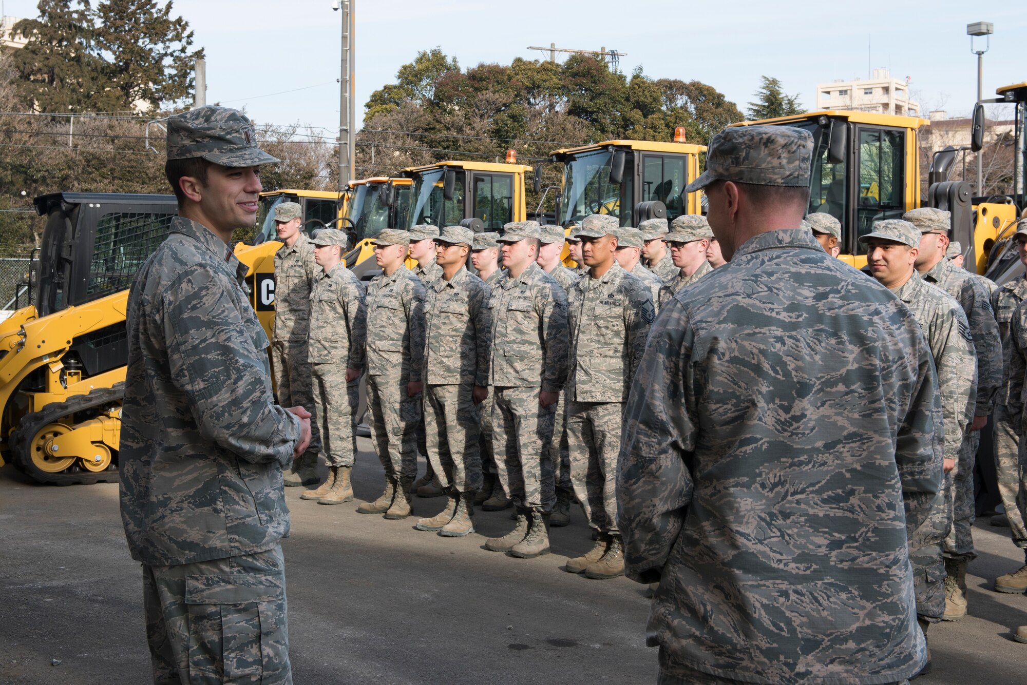2nd Lt. Tucker Axhoj, 374th Civil Engineer Squadron engineering programmer, thanks Col. Jon Winkler, 374th Mission Support Group commander, during the ribbon cutting ceremony for the war reserve materiel storage warehouse at Yokota Air Base, Japan, Feb. 15, 2018.
