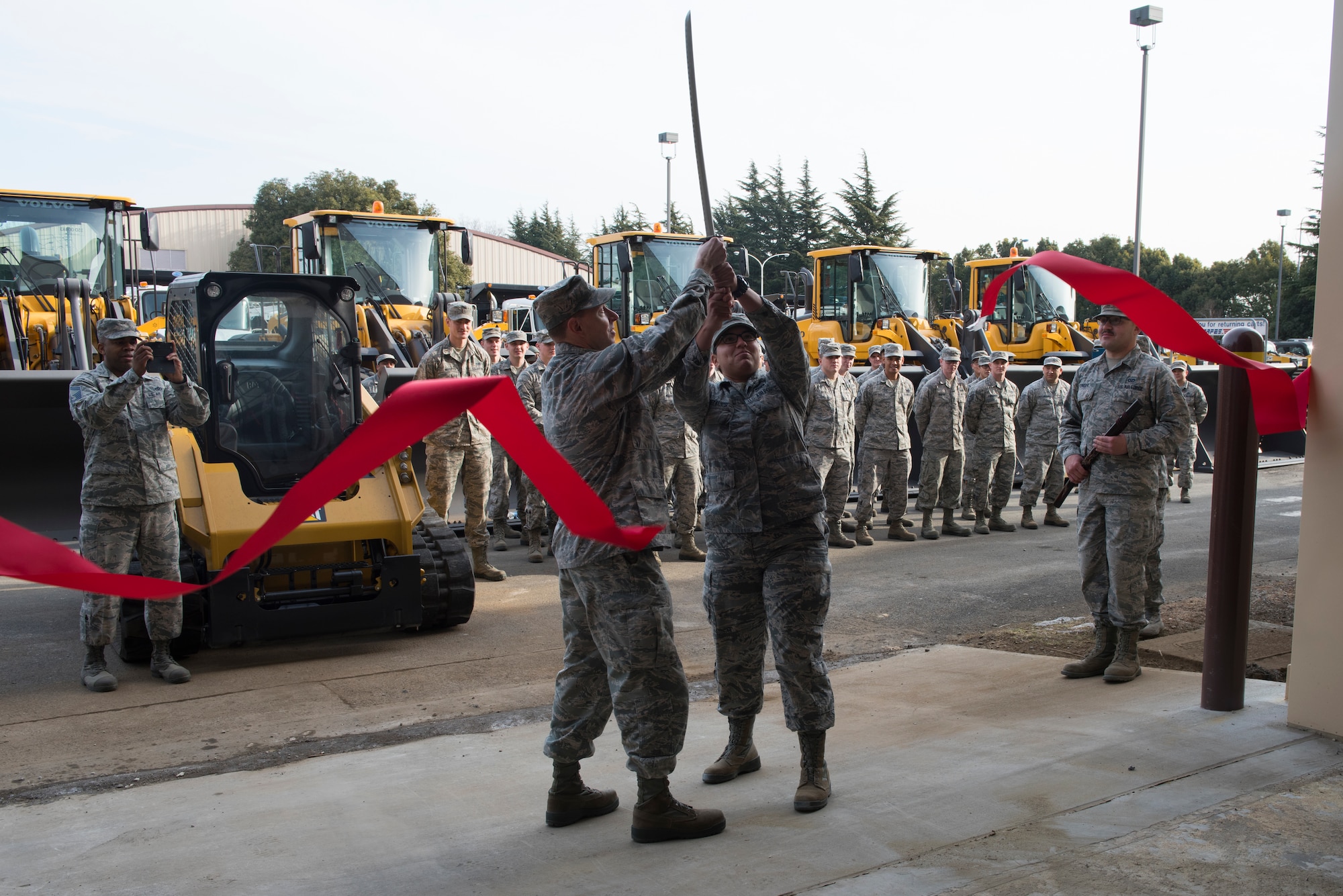 Col. John Winkler, 374th Mission Support Group commander, shares ribbon cutting honors with Airman 1st Class Brianna Gonzales, 374th Civil Engineer Squadron electrical systems apprentice, for the war reserve materiel storage warehouse at Yokota Air Base, Japan, Feb. 15, 2018.