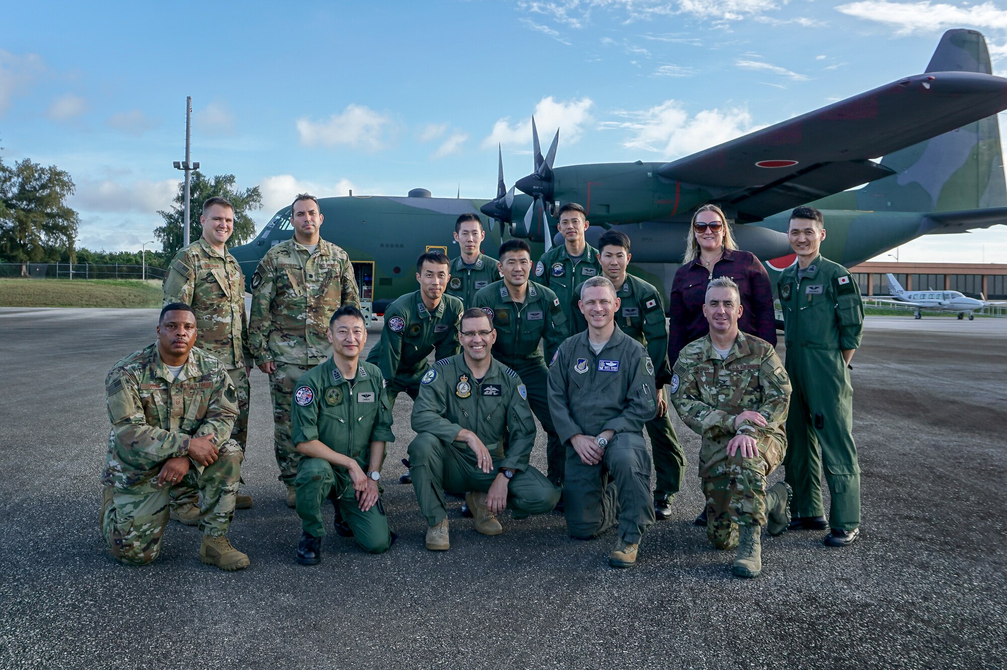 Personnel from U.S. Air Force (USAF) and Koku Jieitai (Japan Air Self-Defense Force) line up to board a JASDF C-130H Hercules during exercise COPE NORTH 2018, Feb. 13. This year's COPE NORTH is an annual Pacific Air Forces tri-lateral humanitarian assistance/disaster relief exercise with participants from the USAF, U.S. Navy, U.S. Marine Corps, Koku Jieitai (Japan Air Self-Defense Force), and Royal Australian Air Force. COPE NORTH is a model opportunity for expanding engagements with the Commonwealth of the Northern Mariana Islands. (U.S. Air Force photo by Capt. James Moore)